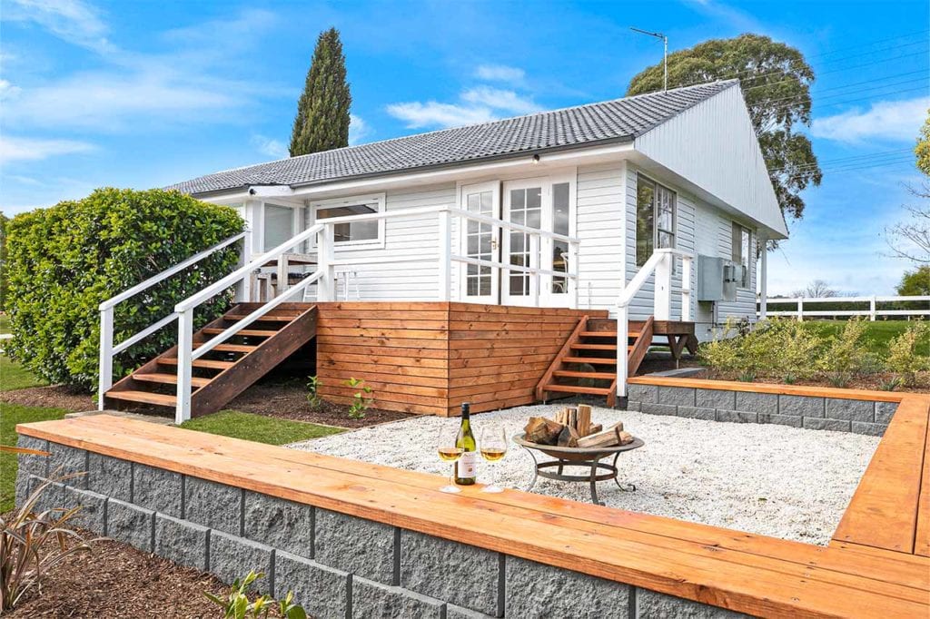 block seating wall and decking around an outdoor firepit