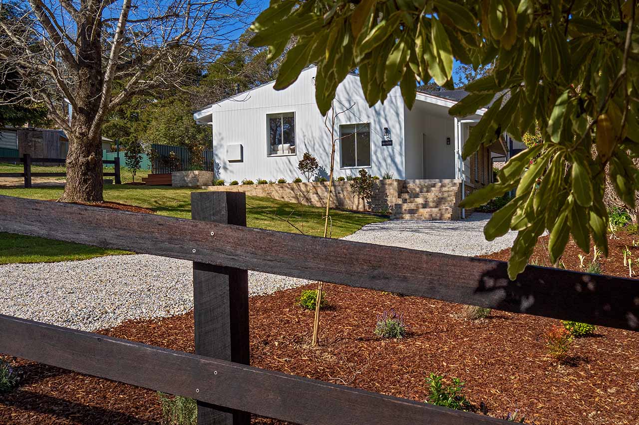 Post and rail fence at front garden landscape renovation modern cottage